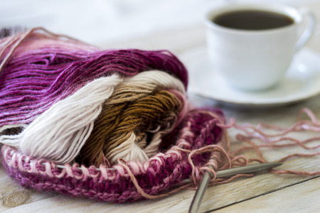 Skeins of wool and knitting needles on wooden backgroundの写真素材
