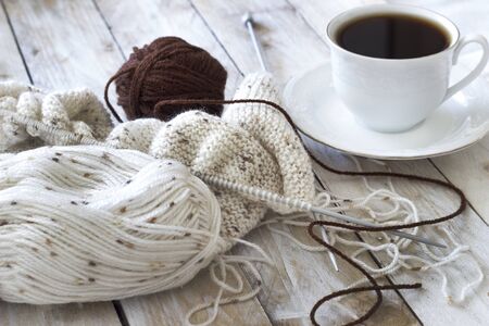 Skeins of wool and knitting needles on wooden backgroundの写真素材