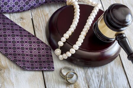 Divorce law concept. Judge gavel, rings, tie and pearl necklaceの写真素材