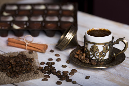 Turkish coffee with chocolate and traditional copper serving set on woodenの写真素材
