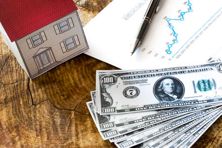 Mortgage, close up of home model, dollar money, investment, real estate and property conceptの写真素材