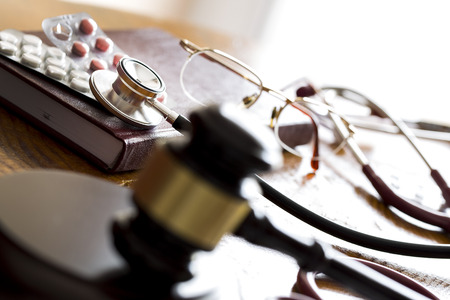 Drug law concept. Judges gavel with stethoscope and pills close up.の写真素材