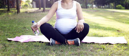 Pregnant woman exercising. Young pregnant womanの写真素材