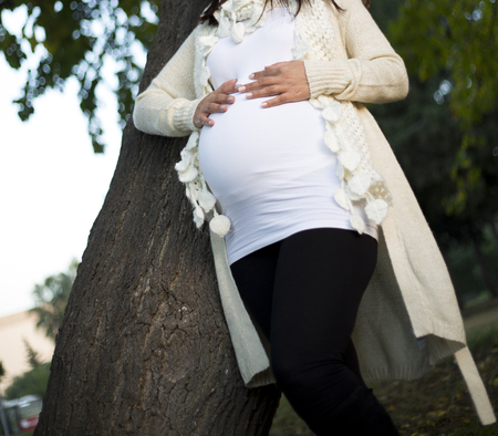 Pregnant Belly in nature. Pregnancy, love, maternity and expectation concept. Pregnant woman...
