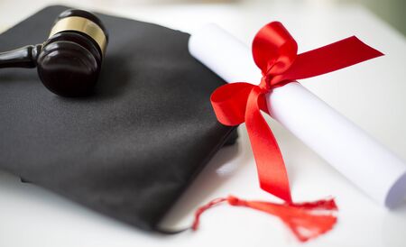 Black graduation cap, degree and gavelの写真素材