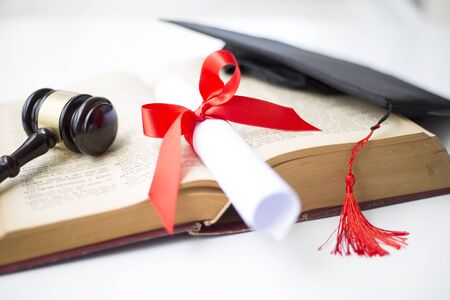 Black graduation cap, degree and gavelの写真素材