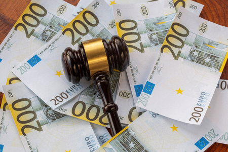 Labor law concept and mallet, background with money Euroの写真素材