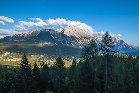 Beautiful alpine countryside. Scenic image of famous Sassolungo peak with overcast perfect blue sky....