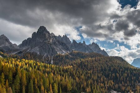 Beautiful alpine countryside. Scenic image of famous Sassolungo peak with overcast perfect blue sky....