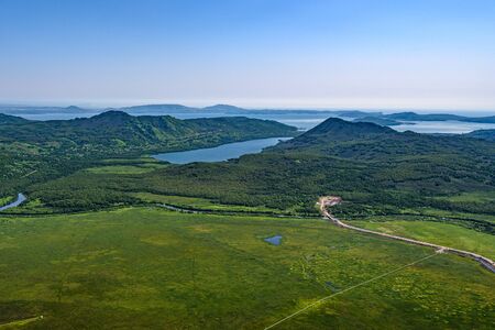 Panoramic view of the city Petropavlovsk-Kamchatsky and volcanoes: Koryaksky Volcano, Avacha Volcano, Kozelsky Volcano. Russian Far East, Kamchatka Peninsula.の写真素材