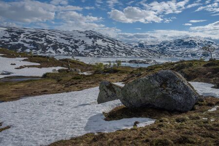 The beautiful illuminated landscape of Norway's mountain lake glacierの写真素材