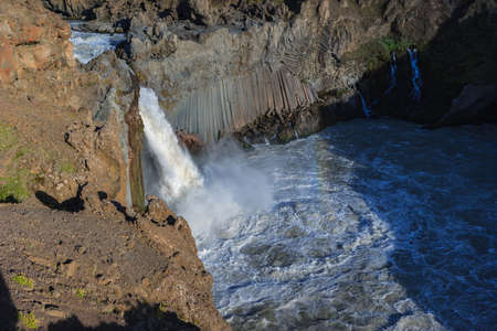 Beautiful Icelandic waterfall at sunset with huge quantity of flowing waters Iceland