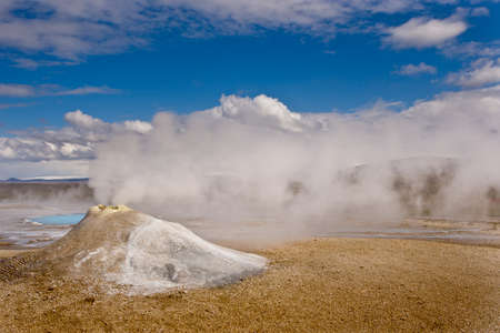 Beautiful colorful Icelandic landscape lava fields mountain geysers zigzag road and moss-covered stones Namafjall, Iceland.の写真素材