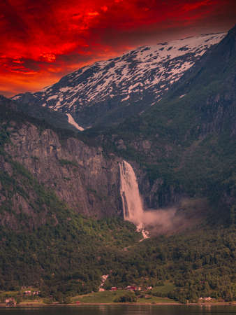 beautiful waterfalls with crystal clear water with mountains in the background at sunset Norway.の写真素材