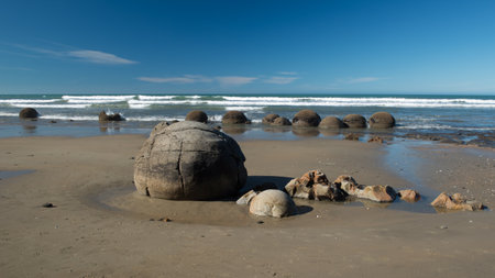 Landmark on the east coast of the South Island, Moeraki Boulders under a dramatic dawn sky.の写真素材