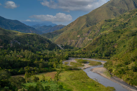 beautiful landscape with a river in the foreground and mountains in the backgroundの写真素材
