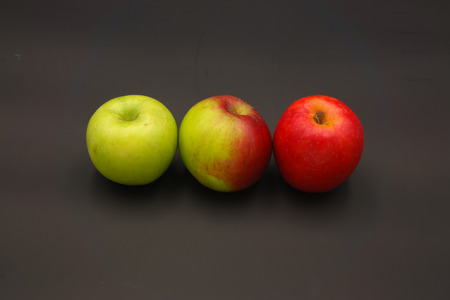 three apples from red to green isolatedの写真素材