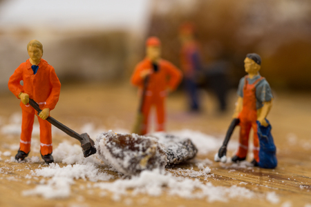 concept Miniature people shoveling snow from boardの写真素材
