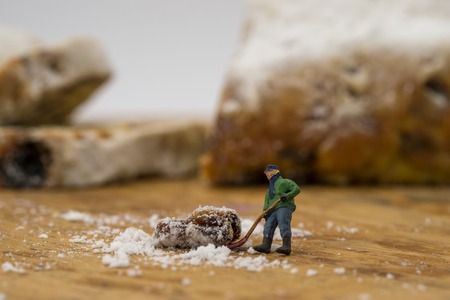 concept Miniature people shoveling snow from board