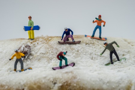 Concept snowboarding on a white mountain with a cakeの写真素材