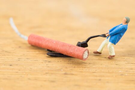 Concept miniature people working hard on Firecrackerの写真素材