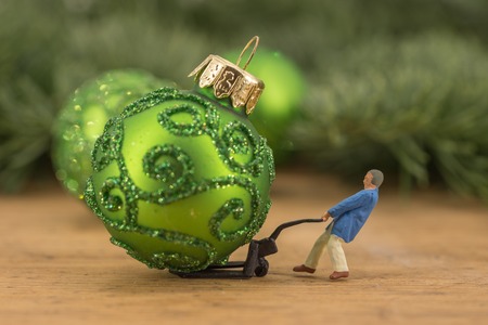 Miniature people worker figures at warehouse christmas balls