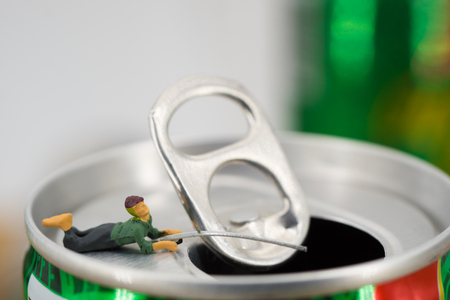 People are fishing on the top of a metal can