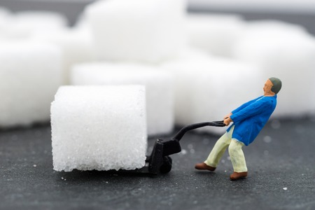 Miniature people Working with sugar. Health care concept.の写真素材