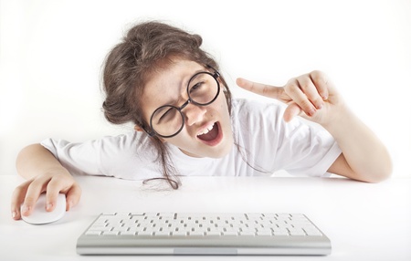 Angry little girl and computerの写真素材