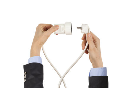 Businesswoman holding power cord and plugの写真素材