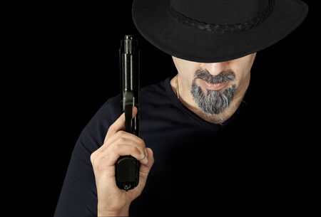 The man in black holding a gunの写真素材