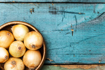 Onion on wooden tableの写真素材