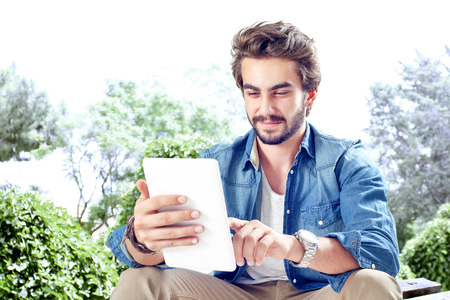 Young man using digital tabletの写真素材