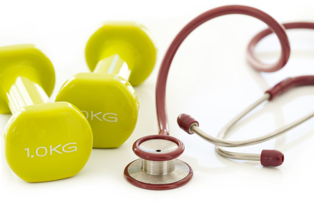 Green dumbbell and stethoscopeの写真素材