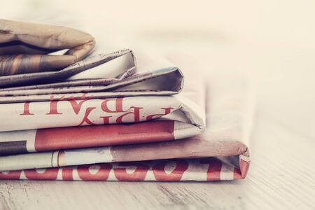 Stack of newspapers on table