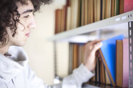 Portrait of young man reading book