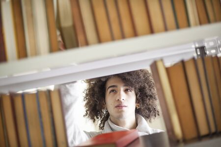 Portrait of young man reading book