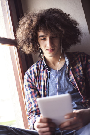 Young man using digital tabletの写真素材