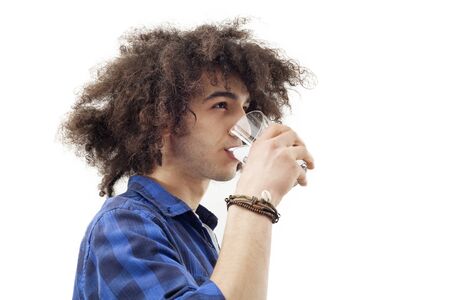 Young man drinking water from glassの写真素材