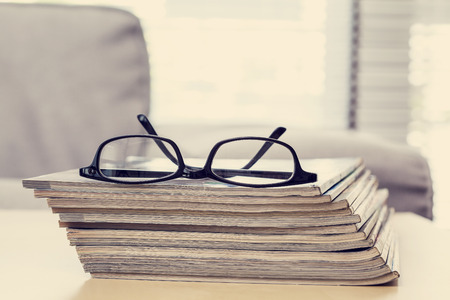 Reading magazine in living roomの写真素材