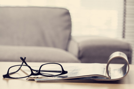 Reading magazine in living roomの写真素材