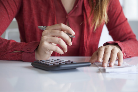 Woman hands with bills on table
