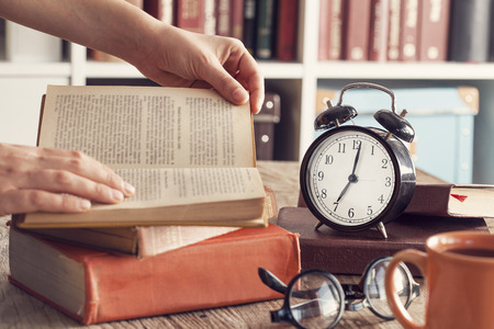 Books with reading glasses on desk