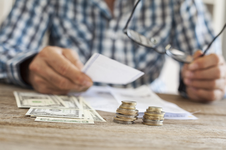 Man hands with bills and moneyの写真素材