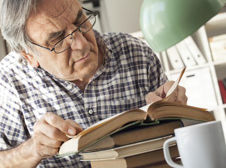 Portrait of man reading bookの写真素材