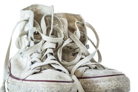 Old white sneakers on white backgroundの写真素材