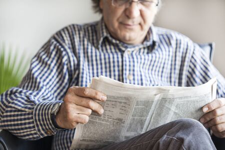 Senior man reading newspaperの写真素材