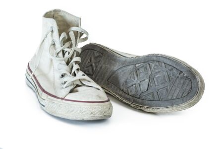 Old white sneakers on white backgroundの写真素材