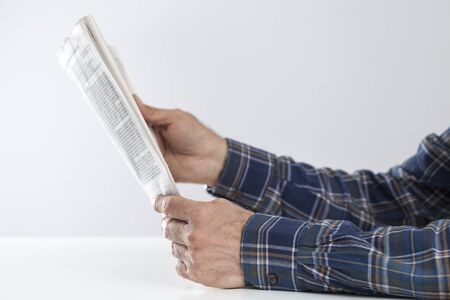 Man reading newspaper on tableの写真素材