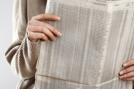 Woman reading newspaper close up viewの写真素材